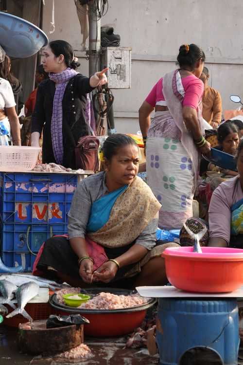 Free A vibrant South Asian fish market with women selling fresh seafood outdoors. Stock Photo