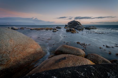 Free Tranquil coastal scene with large rocks at sunrise, captured in Cape Town, South Africa. Stock Photo