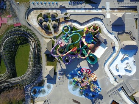 Colorful aerial view of a water park with winding slides and lazy river.