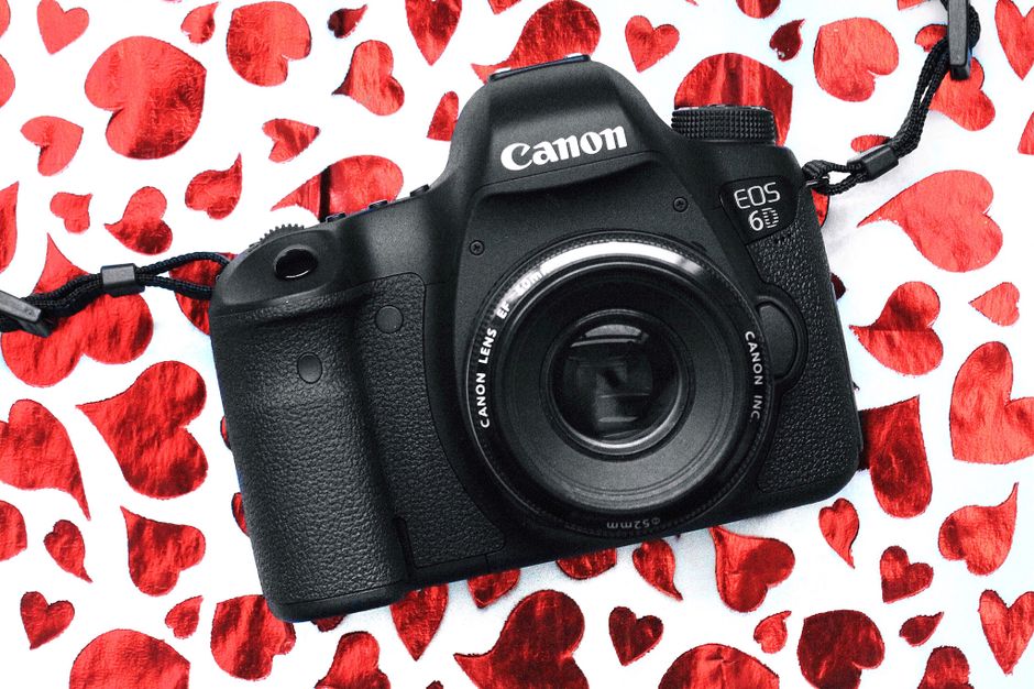 A classic vintage camera on a heart-themed Valentine's Day background, perfect for photography enthusiasts.