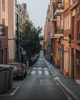 A serene view of a narrow street in Barcelona, showcasing charming architecture.
