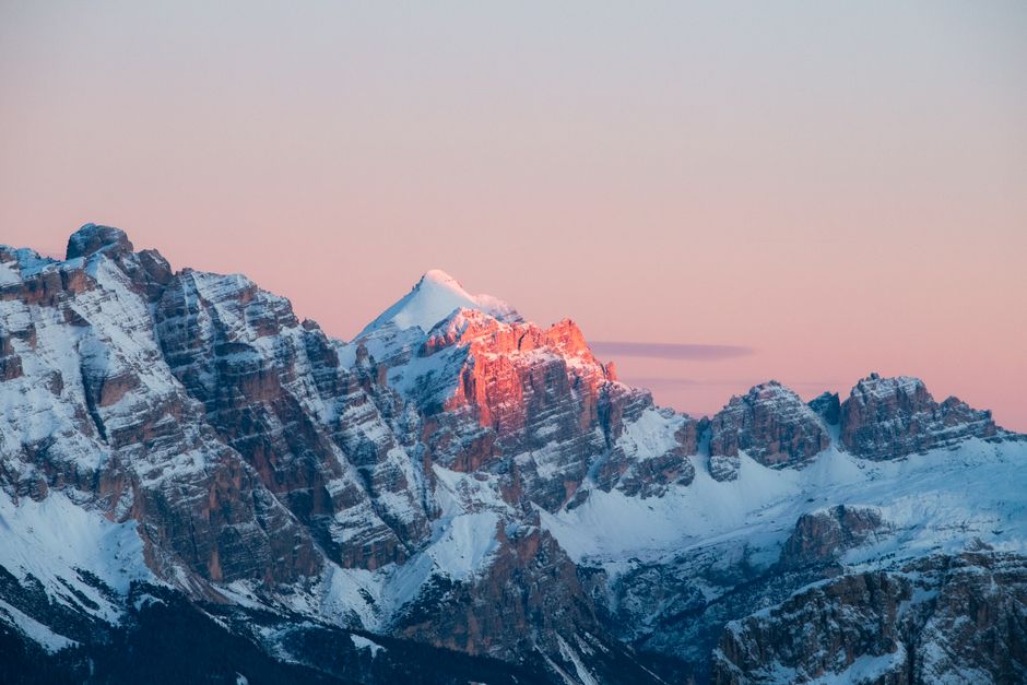 Dramatic view of the Dolomites in Trentino-South Tyrol, Italy at sunset with snow-capped peaks.