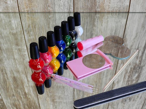 Assorted-color Nail Polish Bottle on Top of Mirror