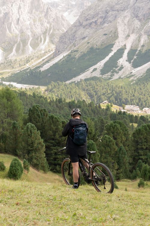 Free Mountain biker enjoys scenic view of Trentino-South Tyrol's rugged landscape. Stock Photo