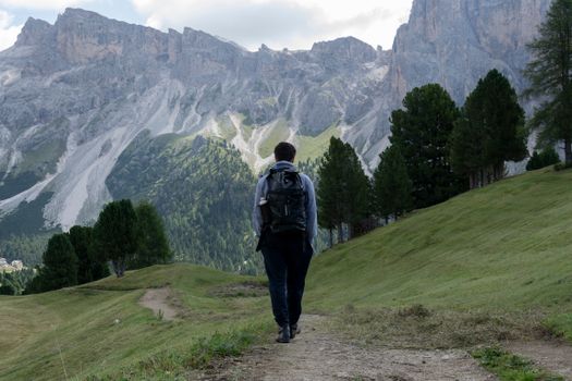 Adventurer hiking through the stunning Dolomites landscape in Trentino-South Tyrol, Italy.