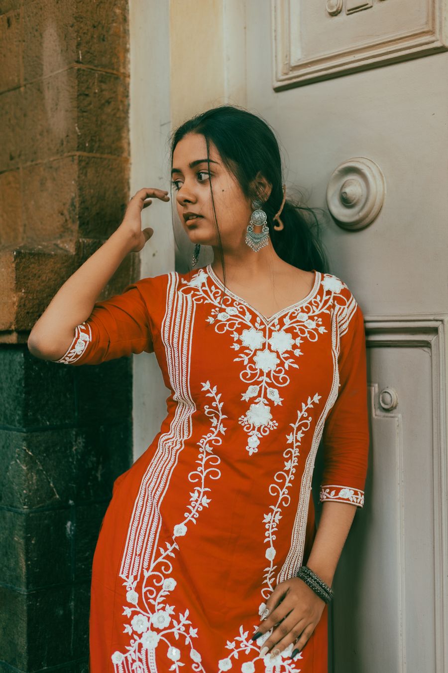 Indian woman in a simple kurti wearing statement earrings
