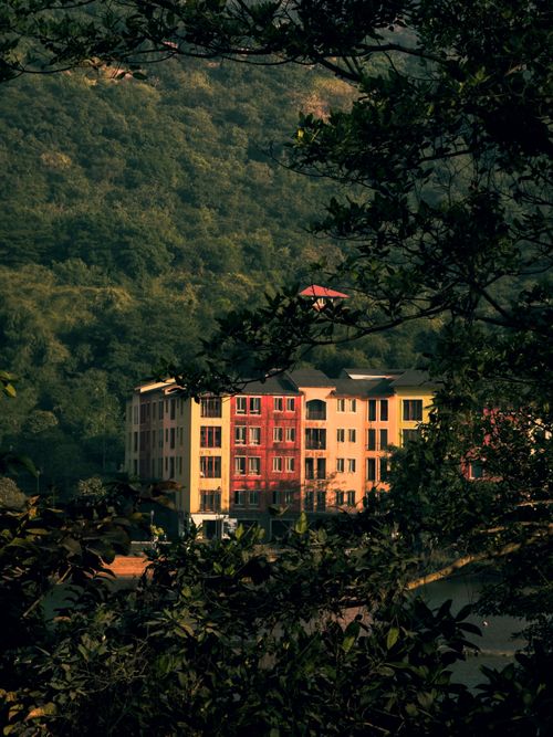 Free Colorful buildings surrounded by lush greenery in Lavasa, India. Stock Photo