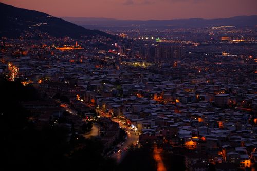 Free Stunning twilight aerial view of a bustling cityscape, capturing vibrant city lights and a serene atmosphere. Stock Photo