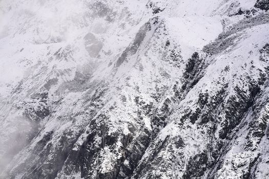 Majestic snow-covered mountain peaks create a serene winter landscape.