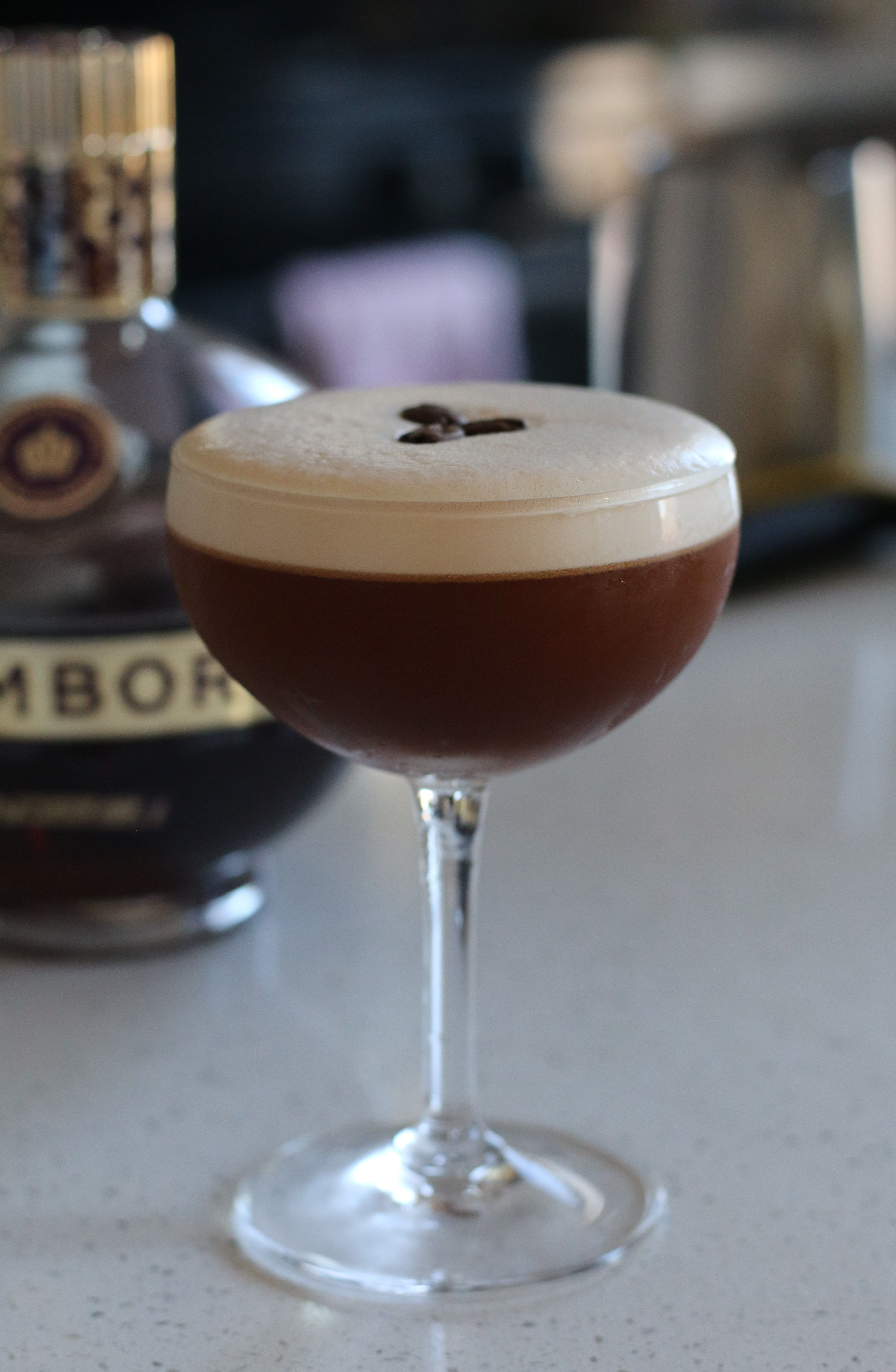 Elegant espresso martini cocktail with coffee bean garnish, ideal for cocktail enthusiasts.