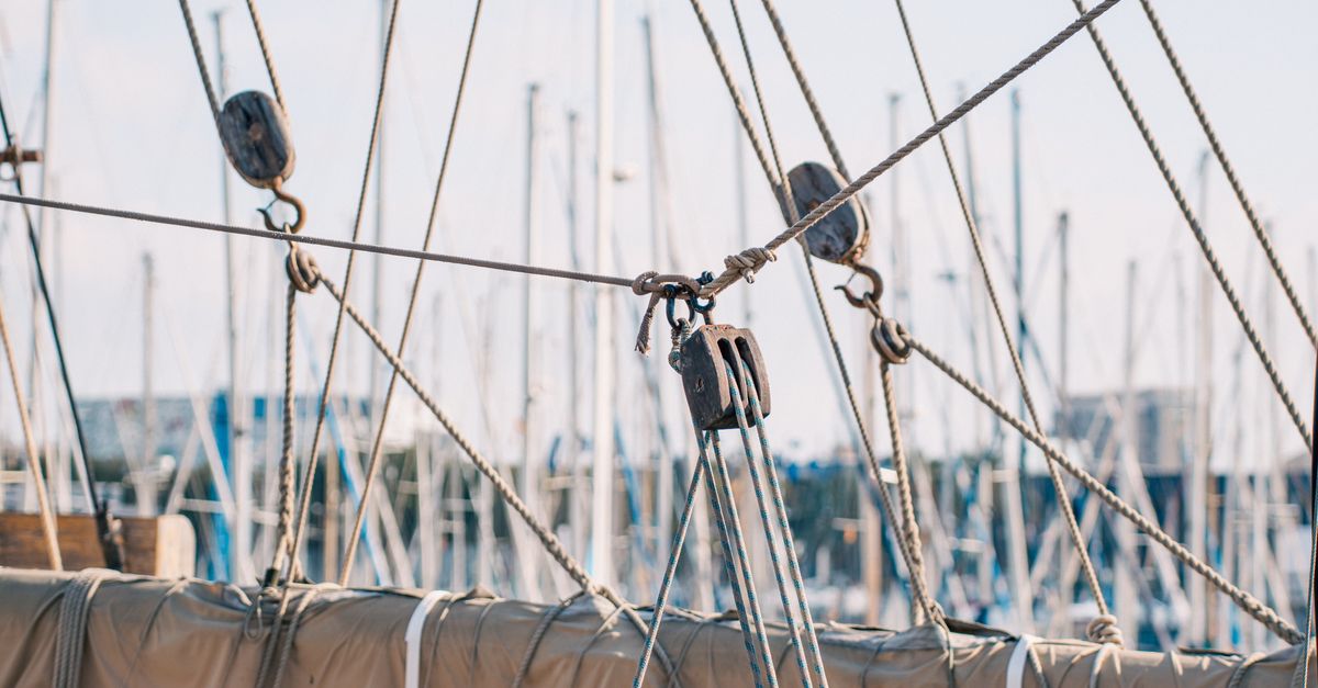 Sailboat Rudder Ropes Sailboat Ropes and Sails in Peaceful Marina · Free Stock Photo
