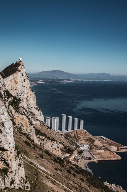 A stunning landscape of the Rock of Gibraltar overlooking the sea and urban structures.