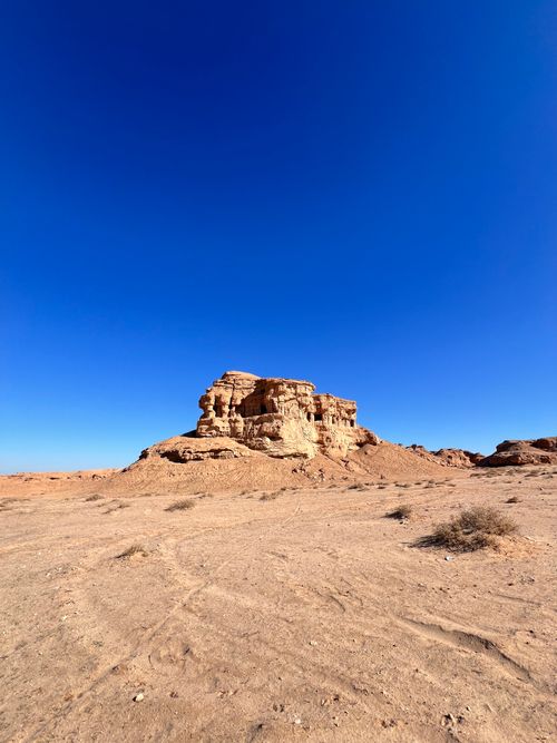 Free Scenic desert landscape featuring rock formations under a clear blue sky in Karbala, Iraq. Stock Photo