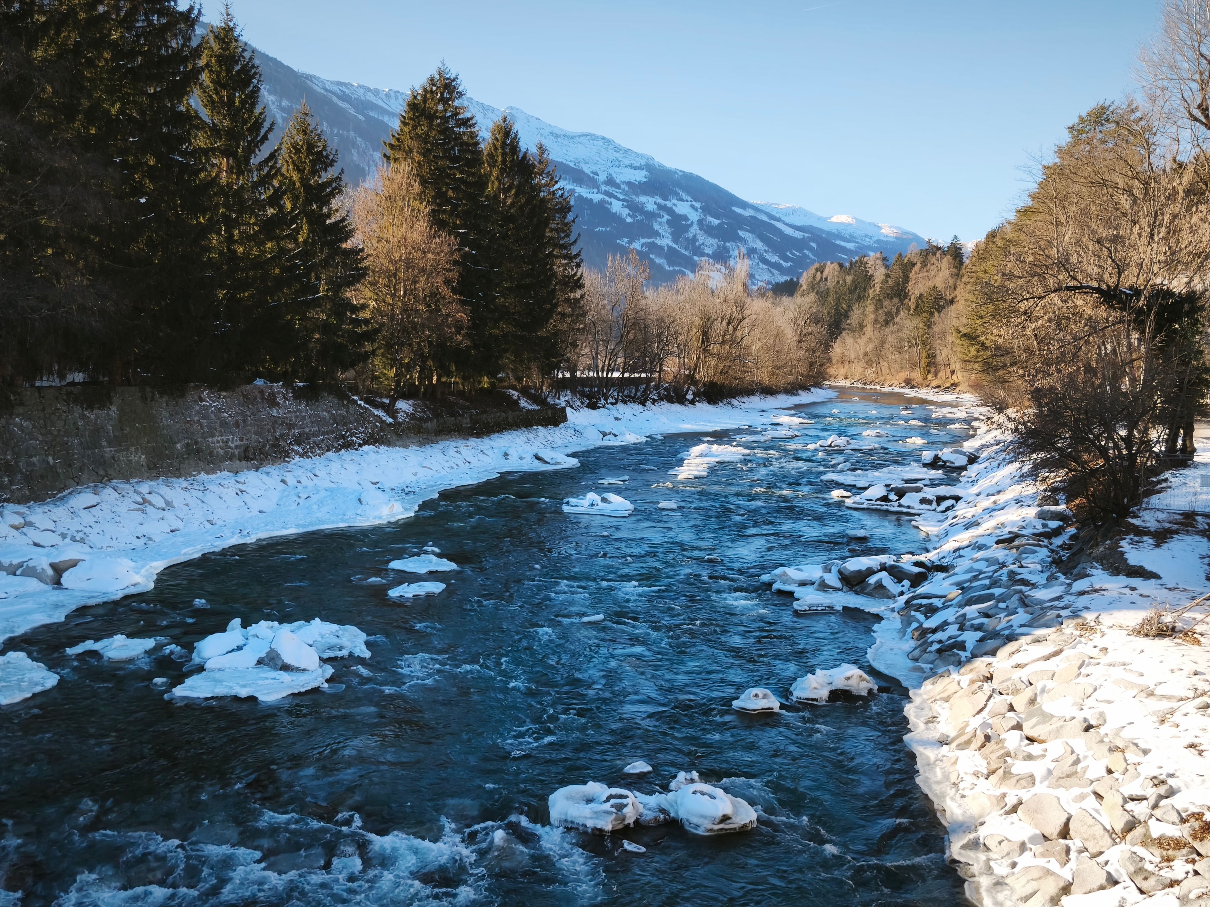 Serene Winter River Landscape with Snowy Mountains · Free Stock Photo