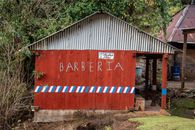 A quaint wooden barber shop with rustic charm in Chiantla, Guatemala.