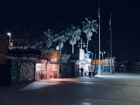 Explore Venice Beach's vibrant night scene with street vendors and iconic murals.