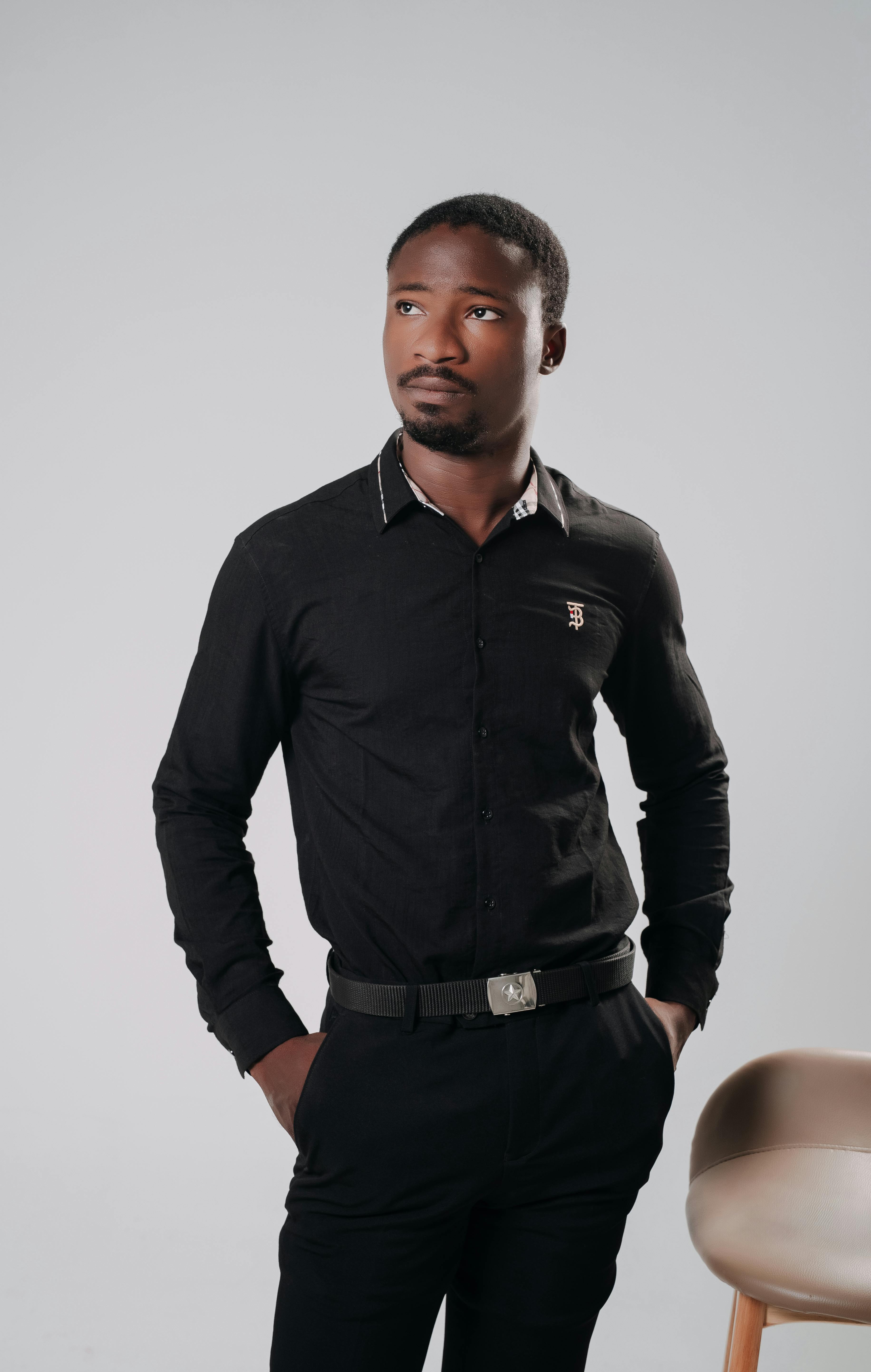 De franc Retrat d'un home segur de si mateix dret en un estudi, amb una camisa negra. Foto d'estoc