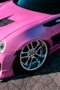 Vibrant Pink Sports Car with Chrome Wheels
