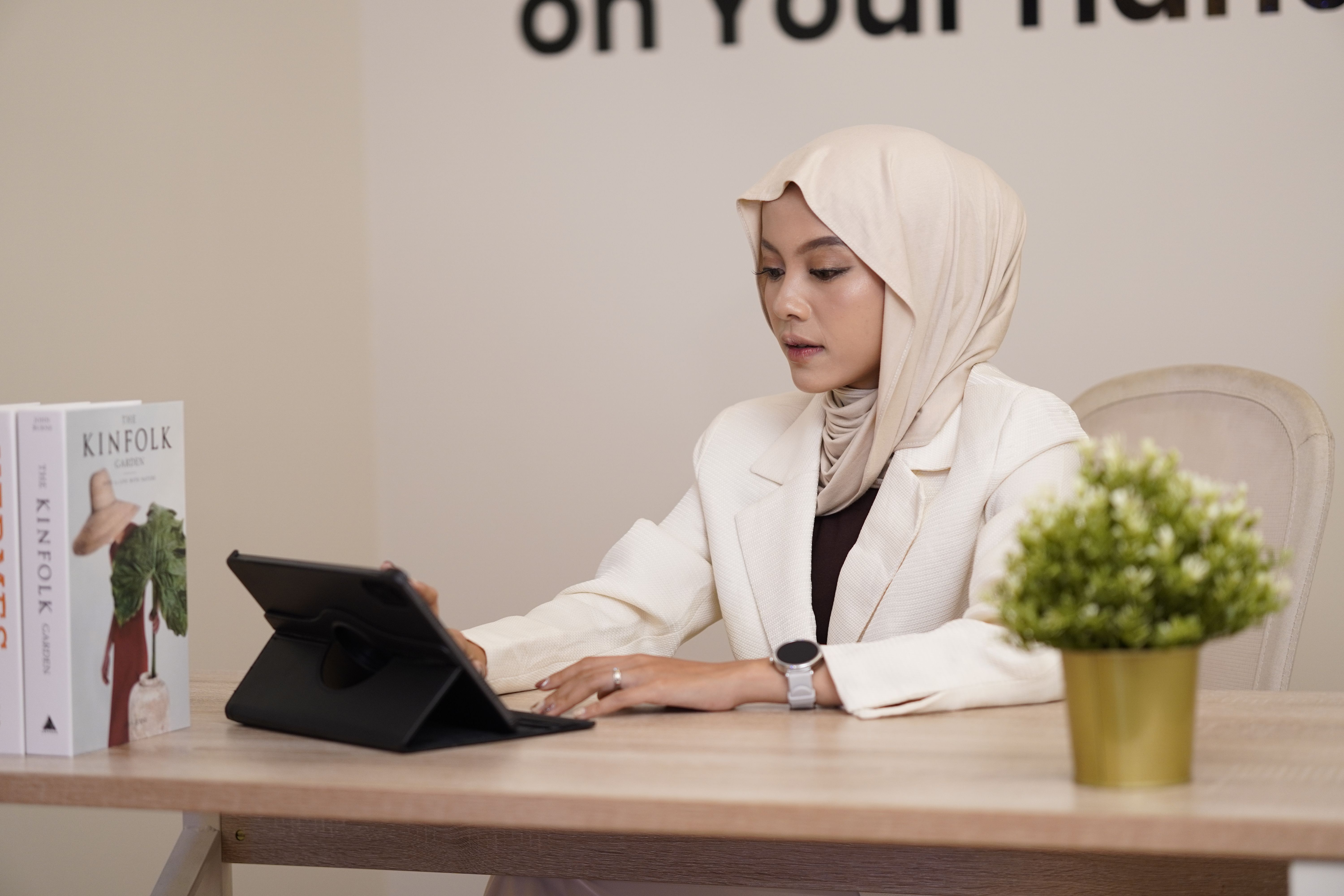 Young Professional Woman Working on Tablet at Desk