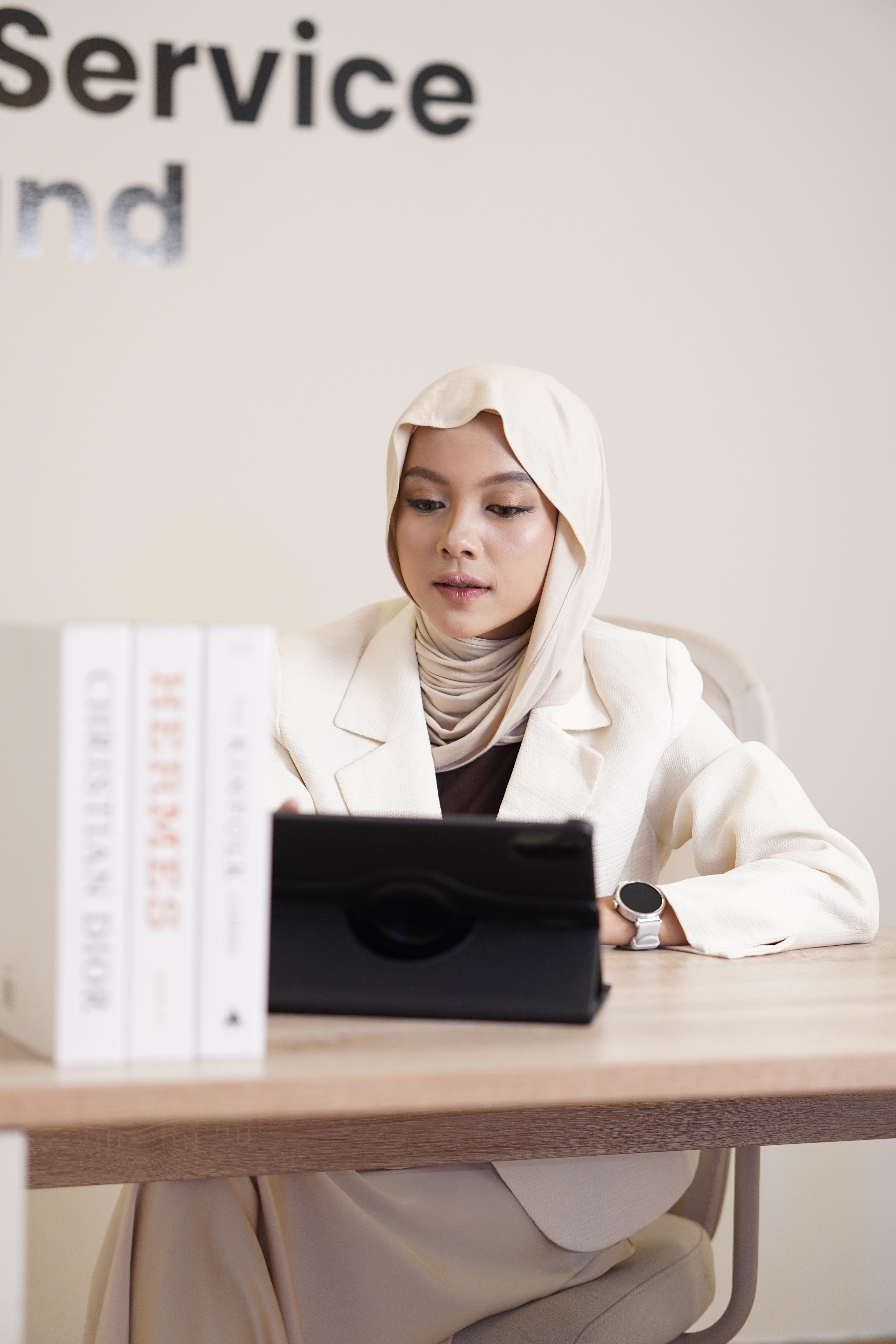 Professional Woman in Hijab Using Tablet at Desk · Free Stock Photo