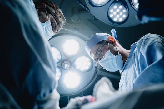 Surgeons in action under bright lights during a medical procedure in a hospital in Mexico.