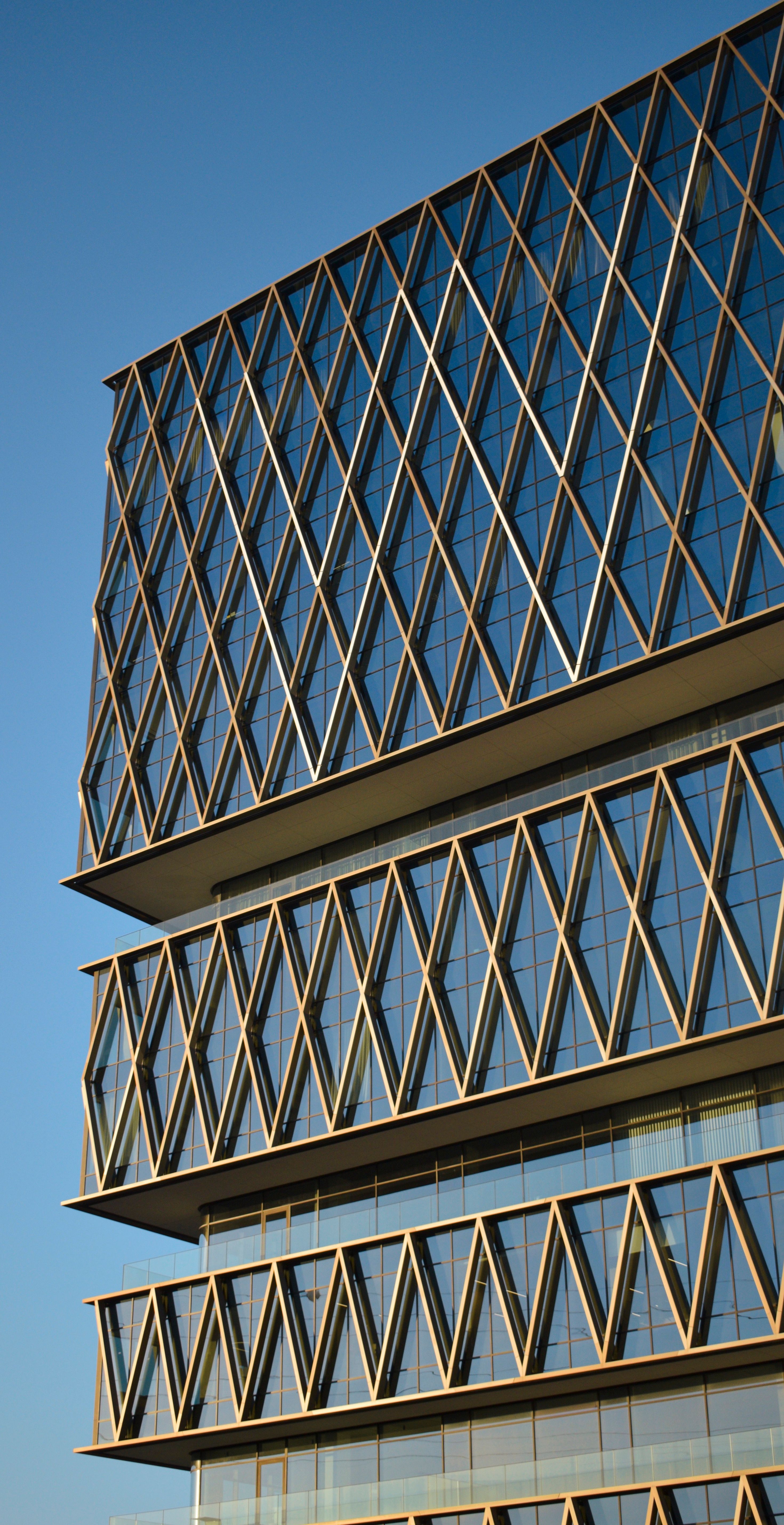 Modern Architectural Glass Facade Under Blue Sky · Free Stock Photo