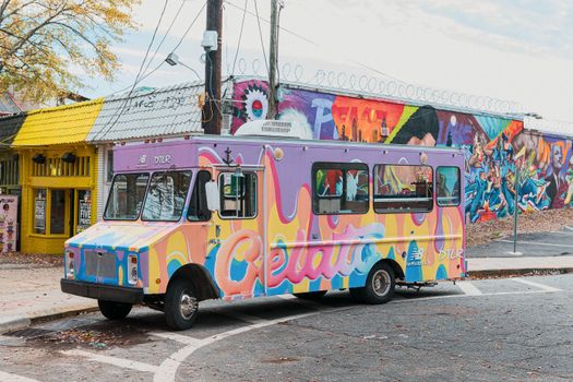 Colorful gelato truck parked by mural art in Little Five Points, Atlanta, Georgia.