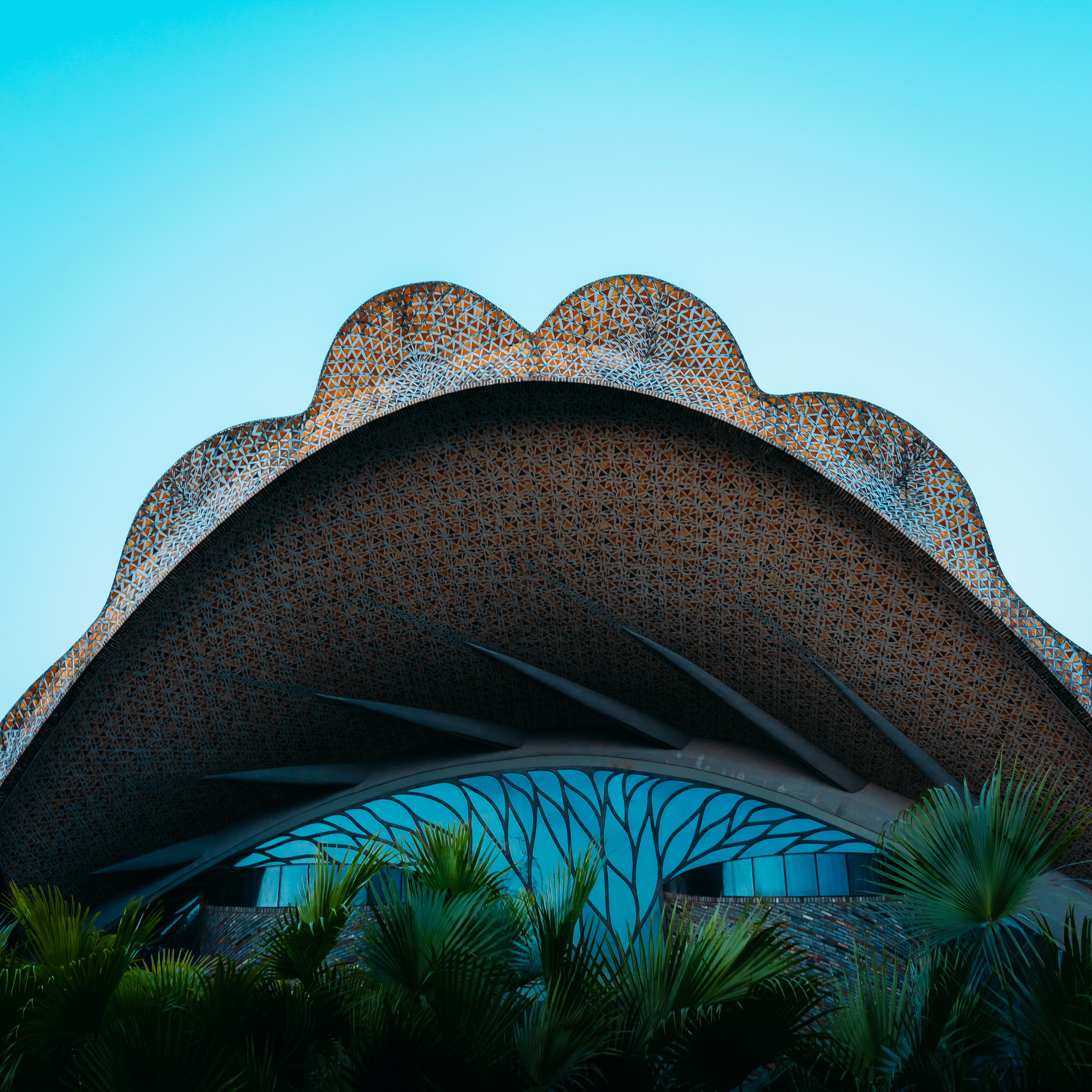 Unique architectural structure with intricate curved roof design and modern aesthetic.
