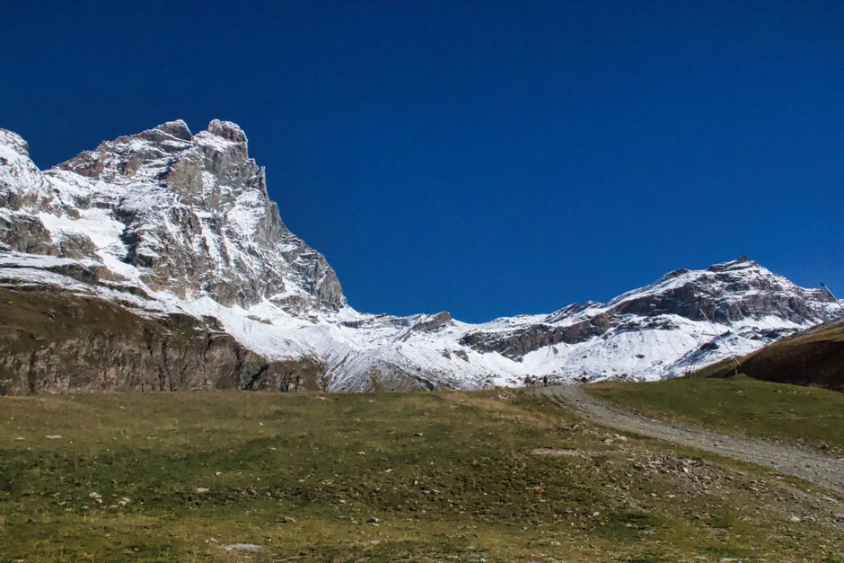 Snow-capped Cervino Mountain against a clear blue sky in Breuil-Cervinia, Italy.