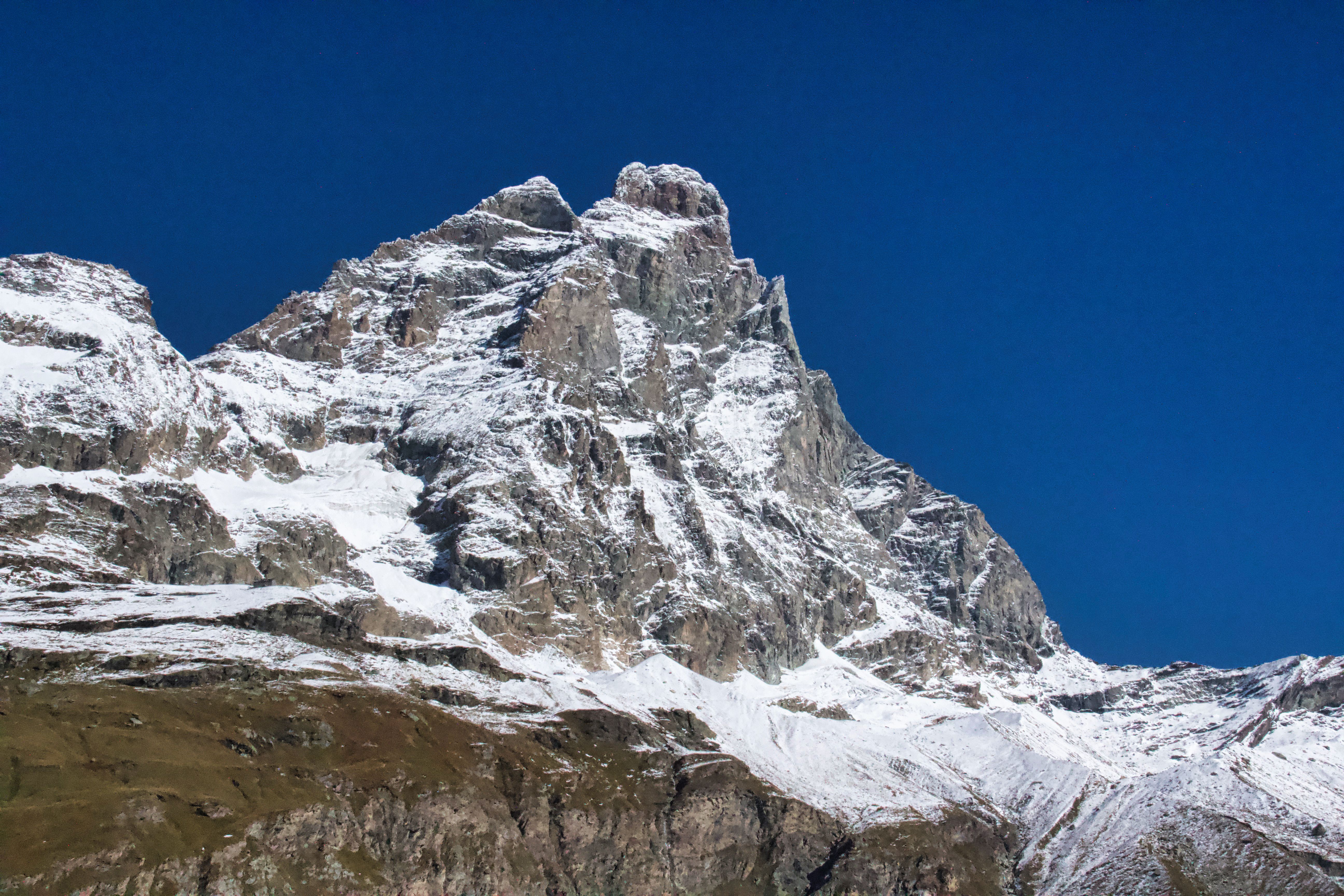 Stunning snow-capped Mount Cervino photographed in Breuil-Cervinia under a clear blue sky.