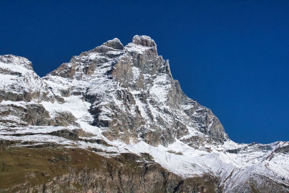 Stunning snow-capped Mount Cervino photographed in Breuil-Cervinia under a clear blue sky.