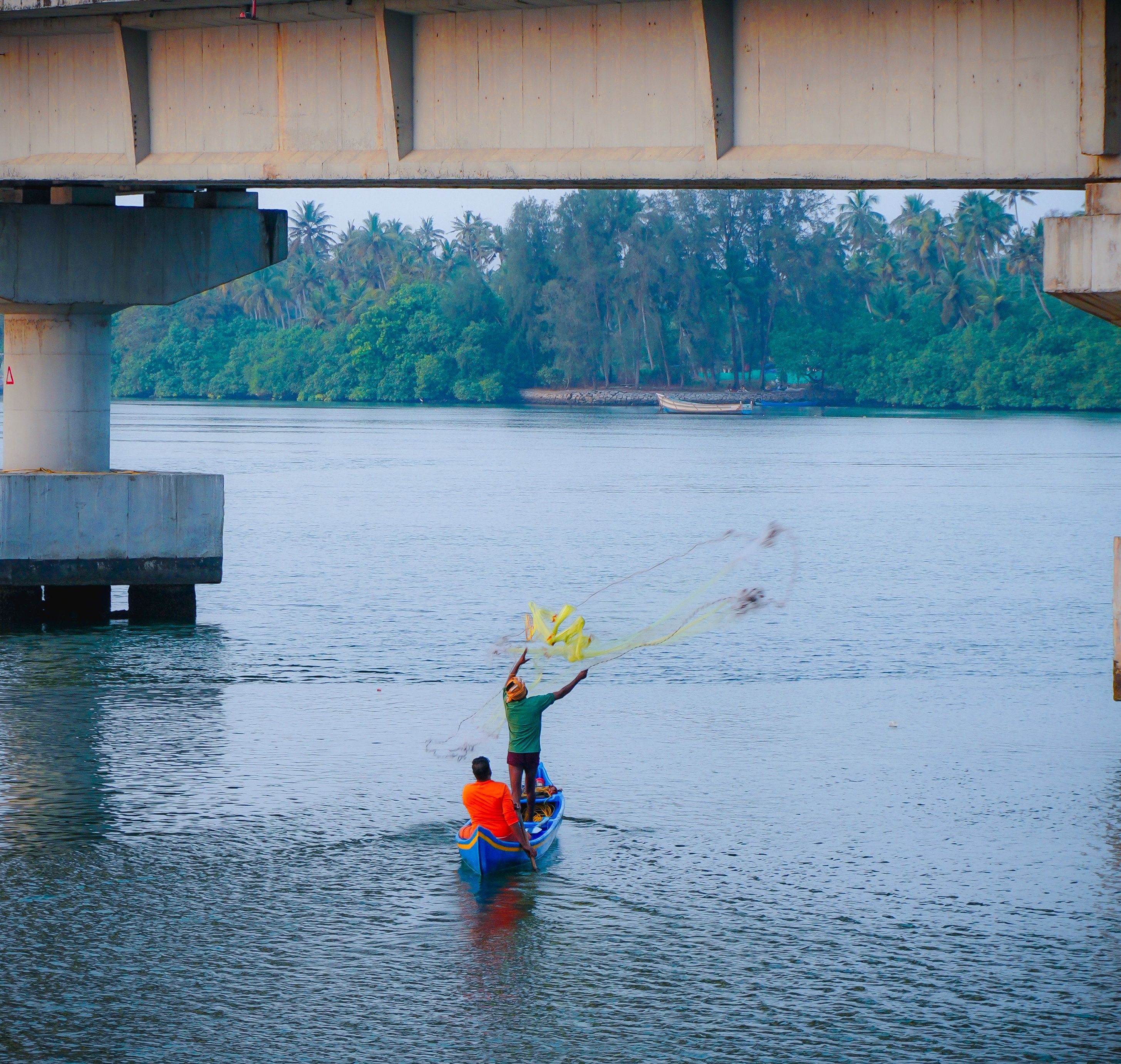 Chinese fishing nets and a country ferry crossing the channel to Vypin island at dusk
