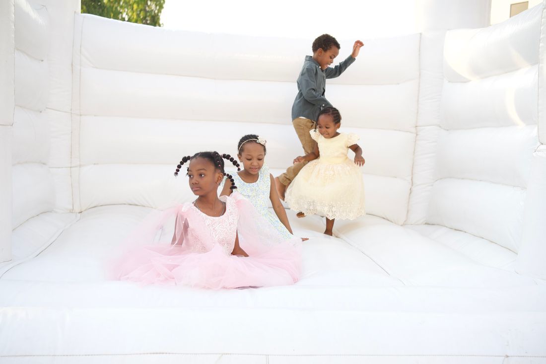 Joyful kids playing on a bouncy castle at a celebration