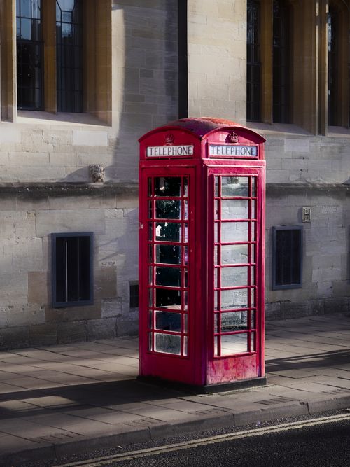 Free Classic red telephone booth on a sidewalk in Oxford, England. Stock Photo