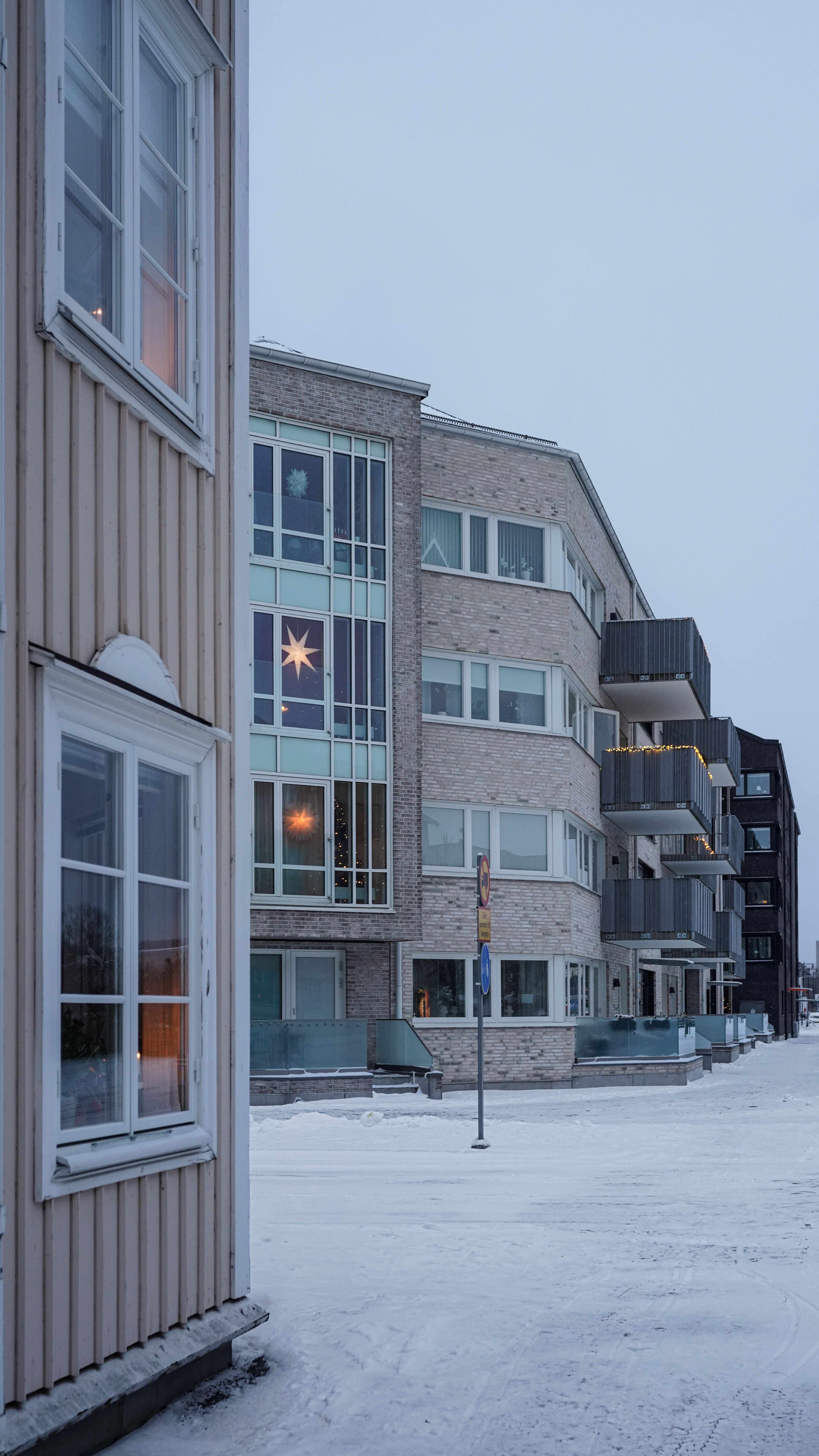 Snowy street with modern apartments in Jönköpings län, Sweden during winter.