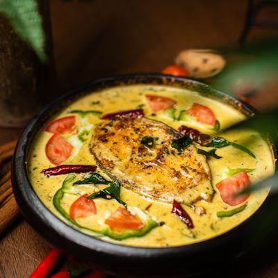 Kerala fish moilee in a dark clay pot