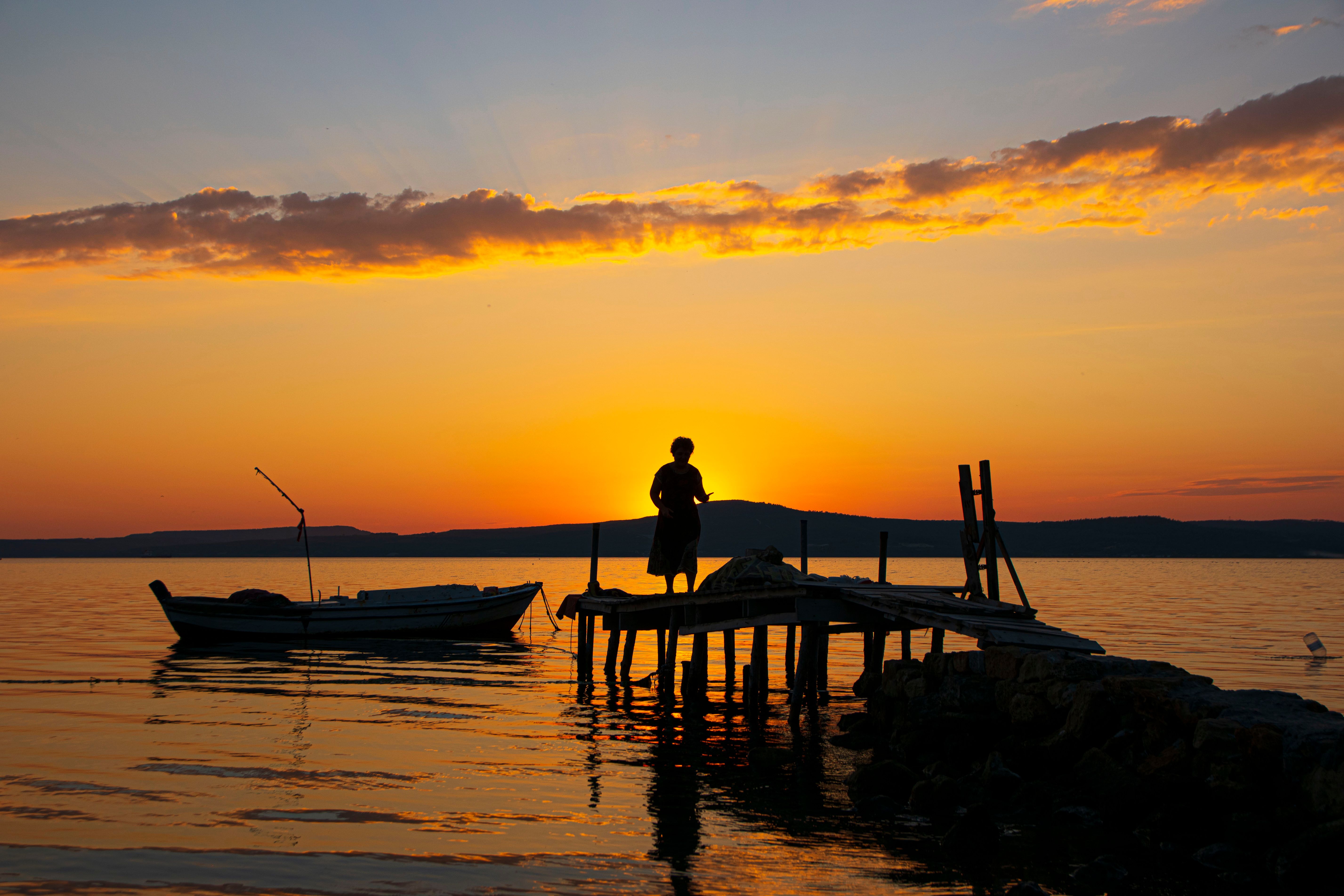 Silhouette of a Person on Dock at Sunset · Free Stock Photo