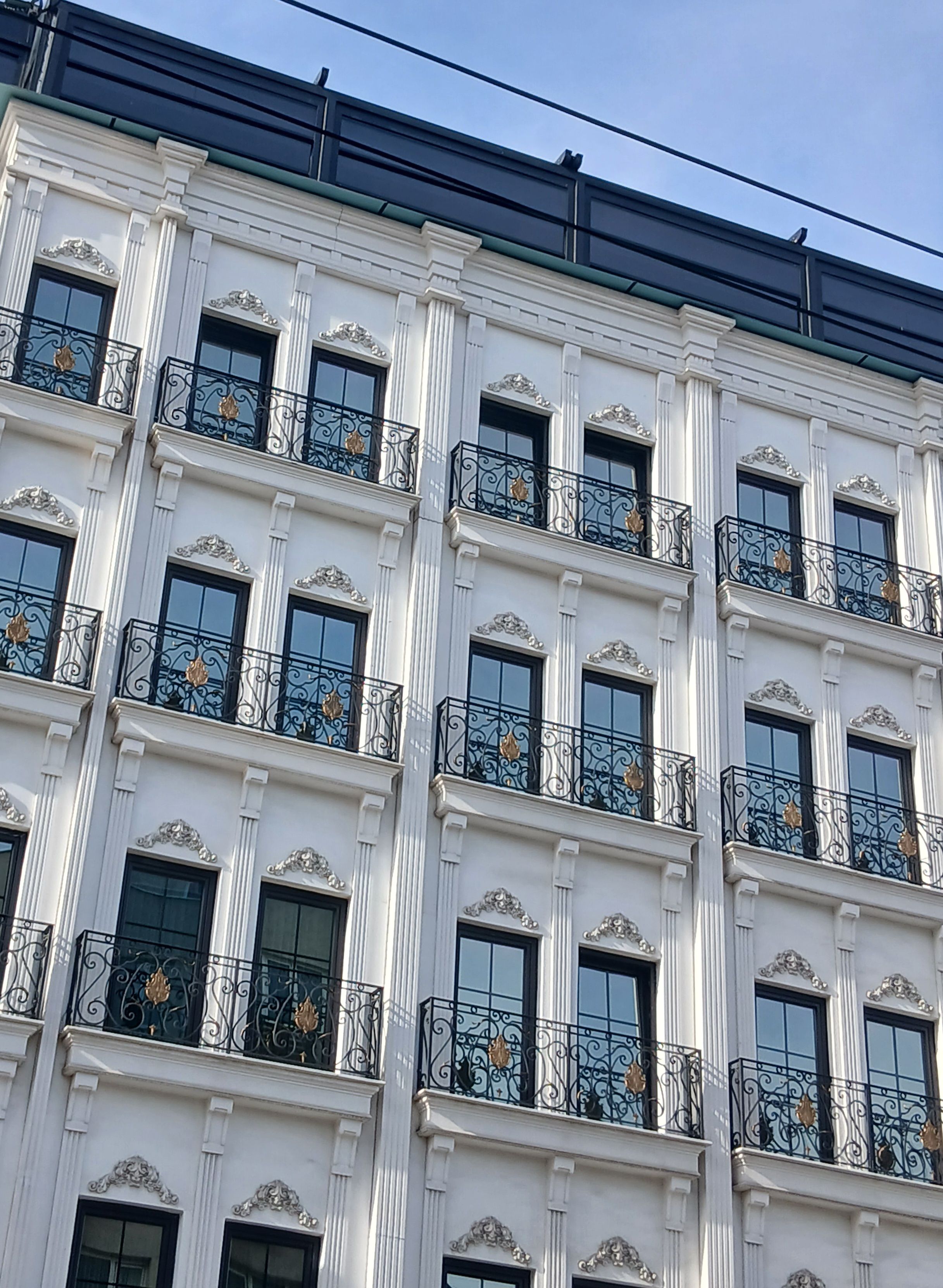 Elegant Classic Building Facade Under Blue Sky · Free Stock Photo