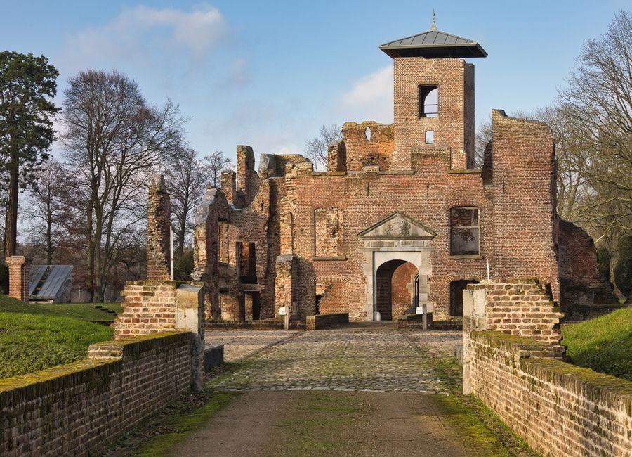 A scenic view of historic brick castle ruins outdoors during the day.
