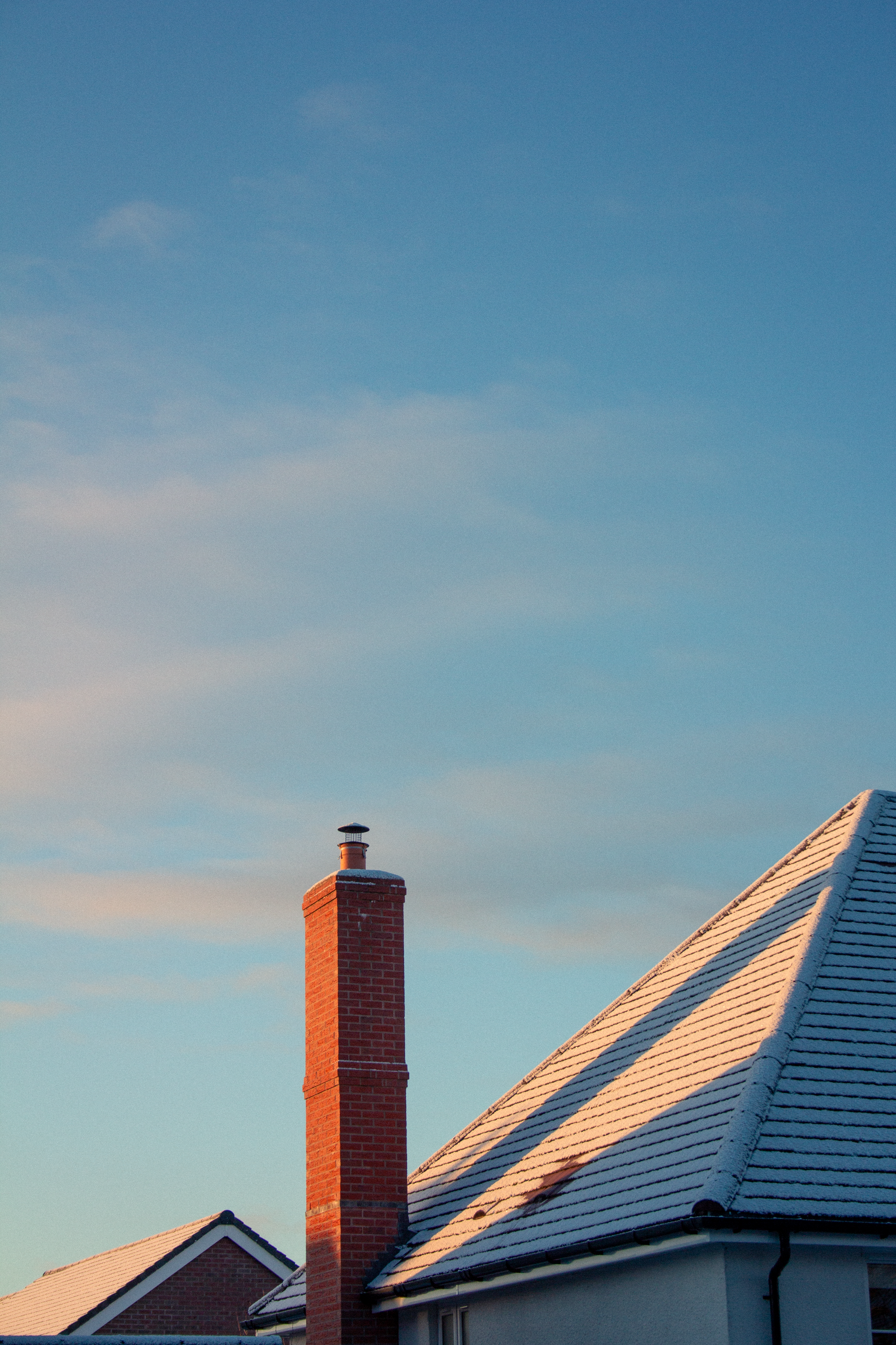 Snow-Covered Rooftop with Brick Chimney in England · Free Stock Photo