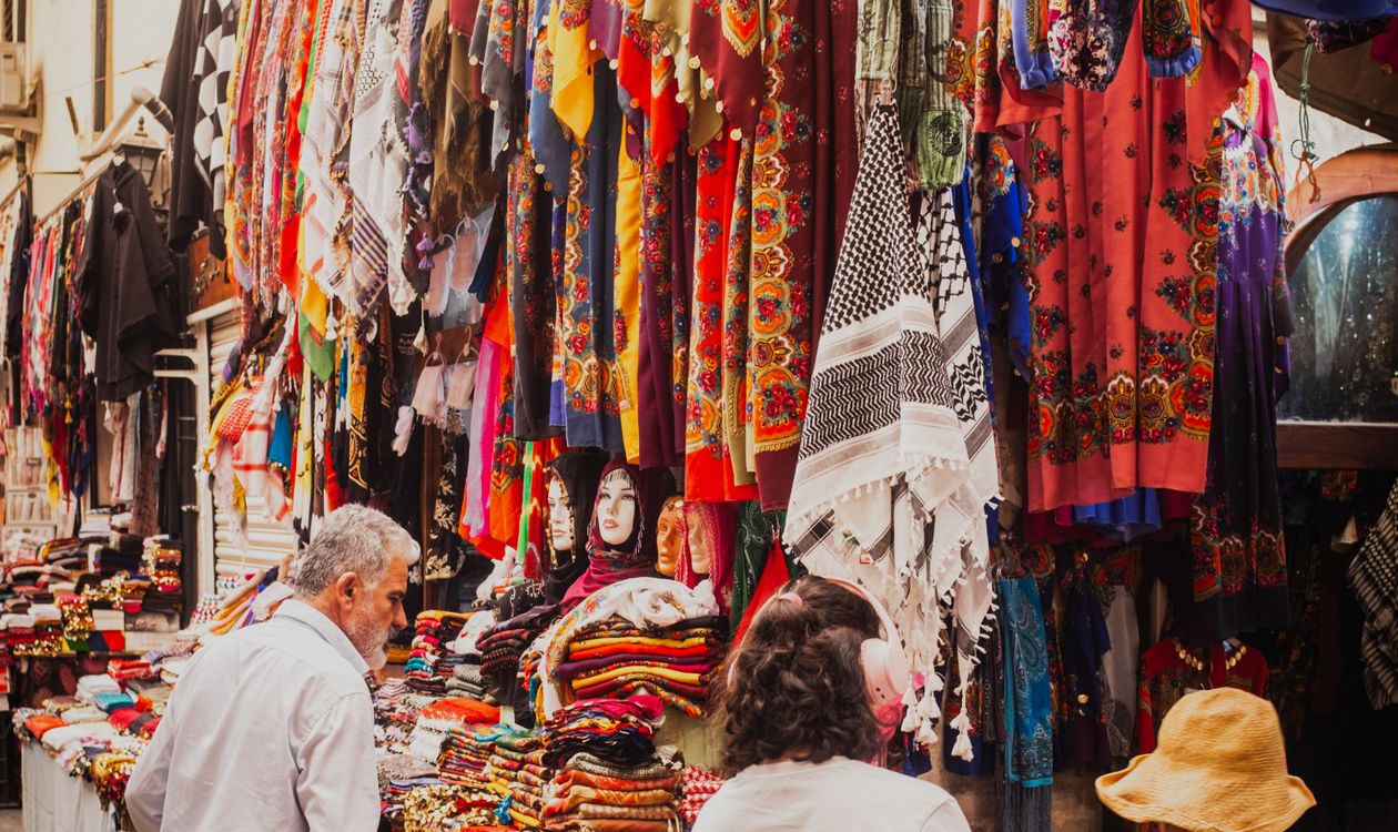 Colourful market stalls draped in vibrant fabrics