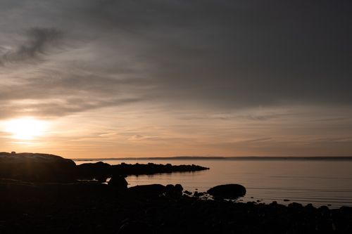 Free A tranquil sunrise over the rocks and water at Cove Island Park, Stamford, Connecticut. Stock Photo