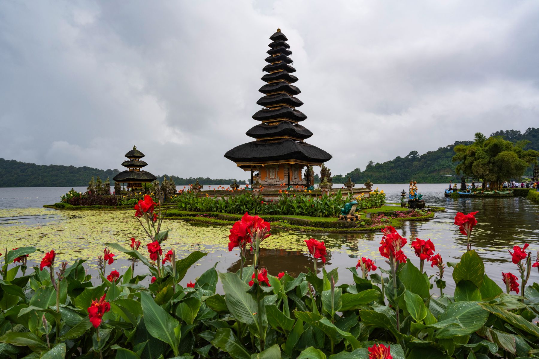 Ulun Danu Beratan temple, lake, flowers, and mountain landscape in Bali