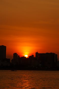 Captivating sunset over Phnom Penh's skyline, casting a warm glow.