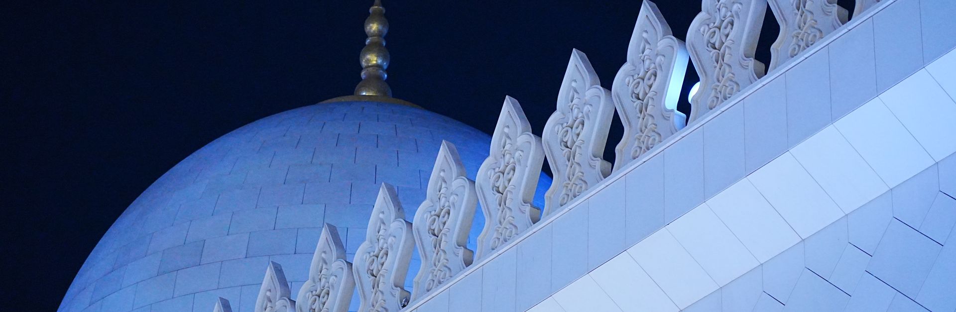 A striking view of the Sheikh Zayed Grand Mosque's dome under the night sky in Abu Dhabi.