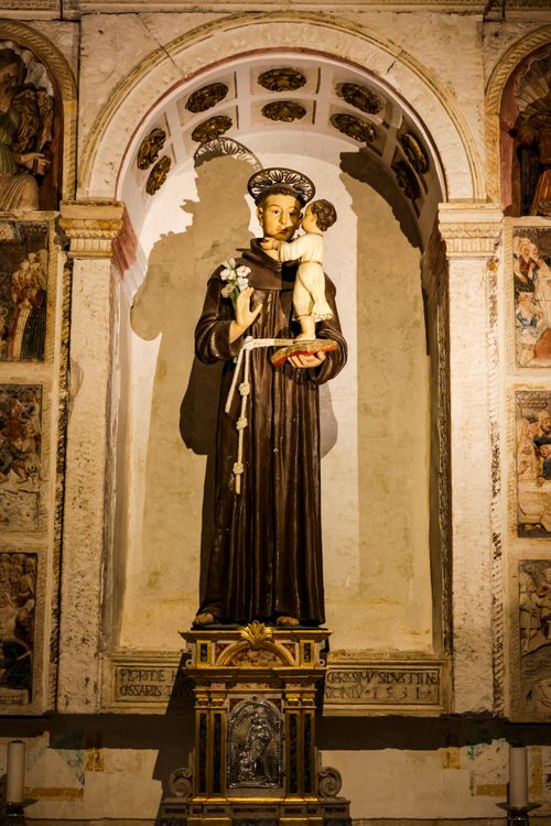 Free Statue of Saint Anthony with child inside an ancient cathedral. Stock Photo
