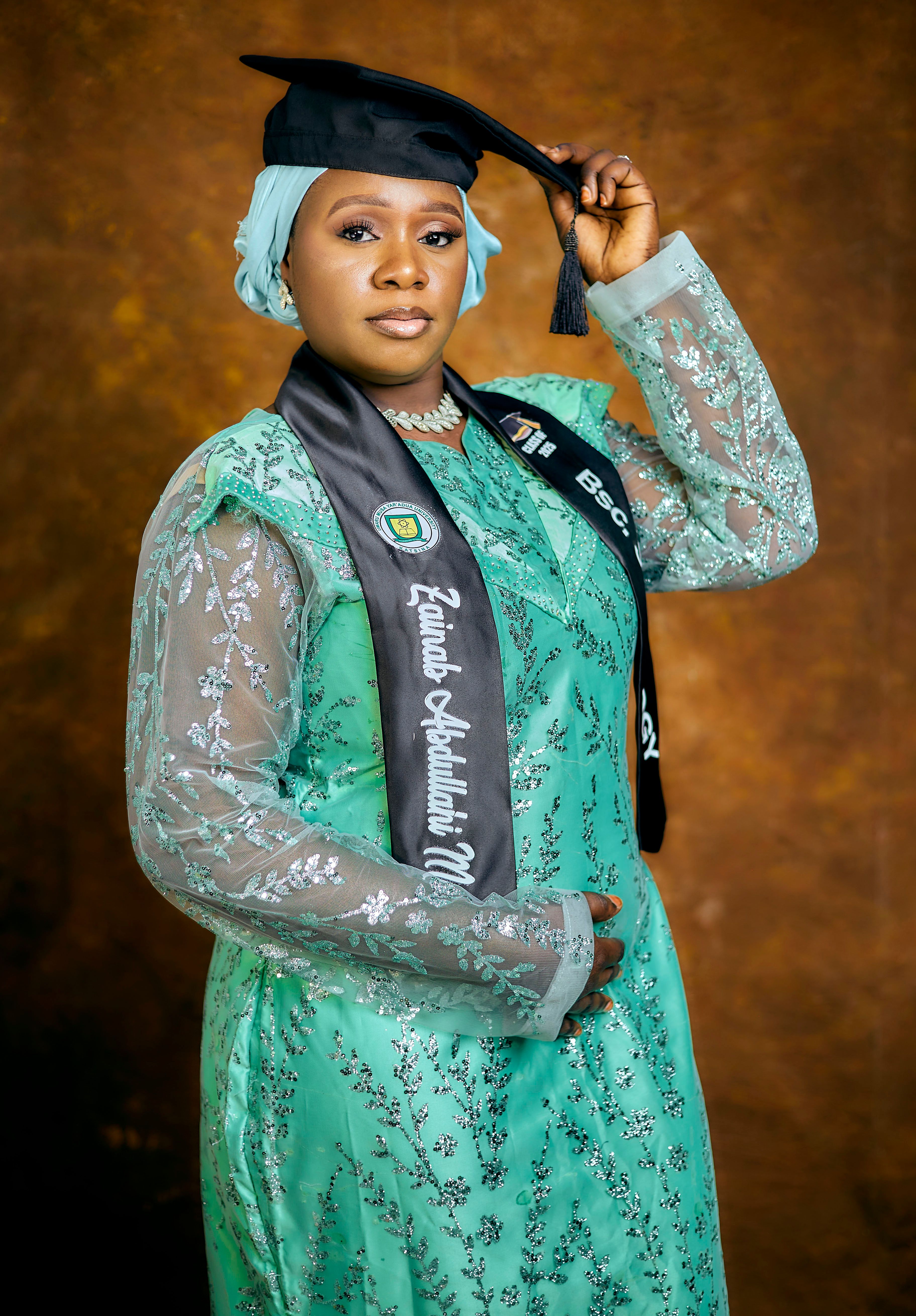 Portrait of a woman in graduation attire, celebrating success.