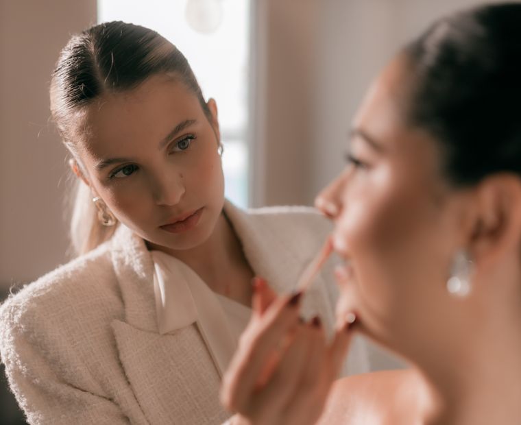 Close-up of lipstick being applied before a wedding