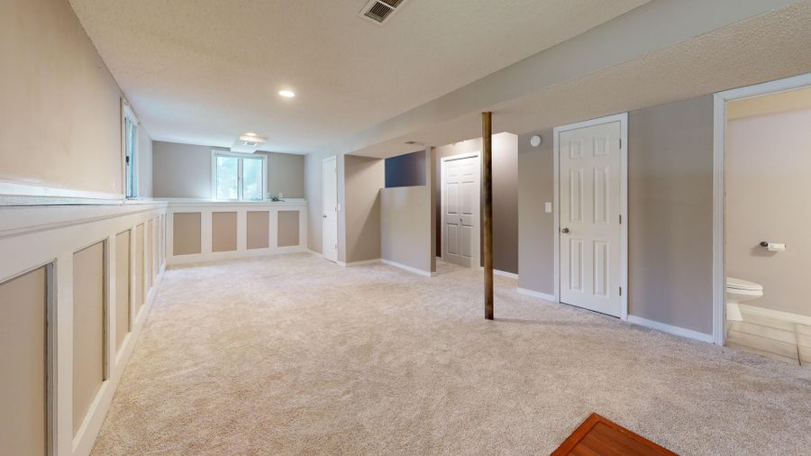 Finished basement with carpet and pot lights