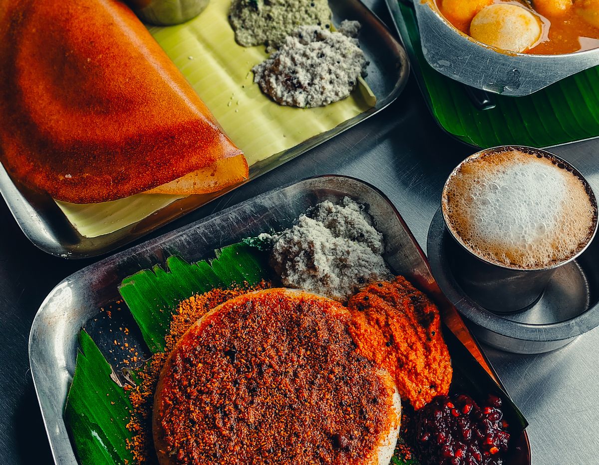 South Indian tiffin spread of dosa, idli, chutneys and sambar on banana leaves